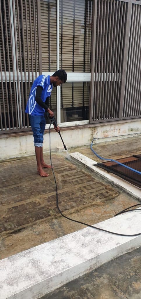 Worker Jet Spraying The Balcony